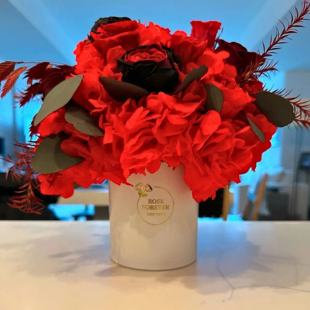 Forever rose bouquet: Ceramic Scarlet red preserved roses and hydrangea in a white ceramic vase on a kitchen counter