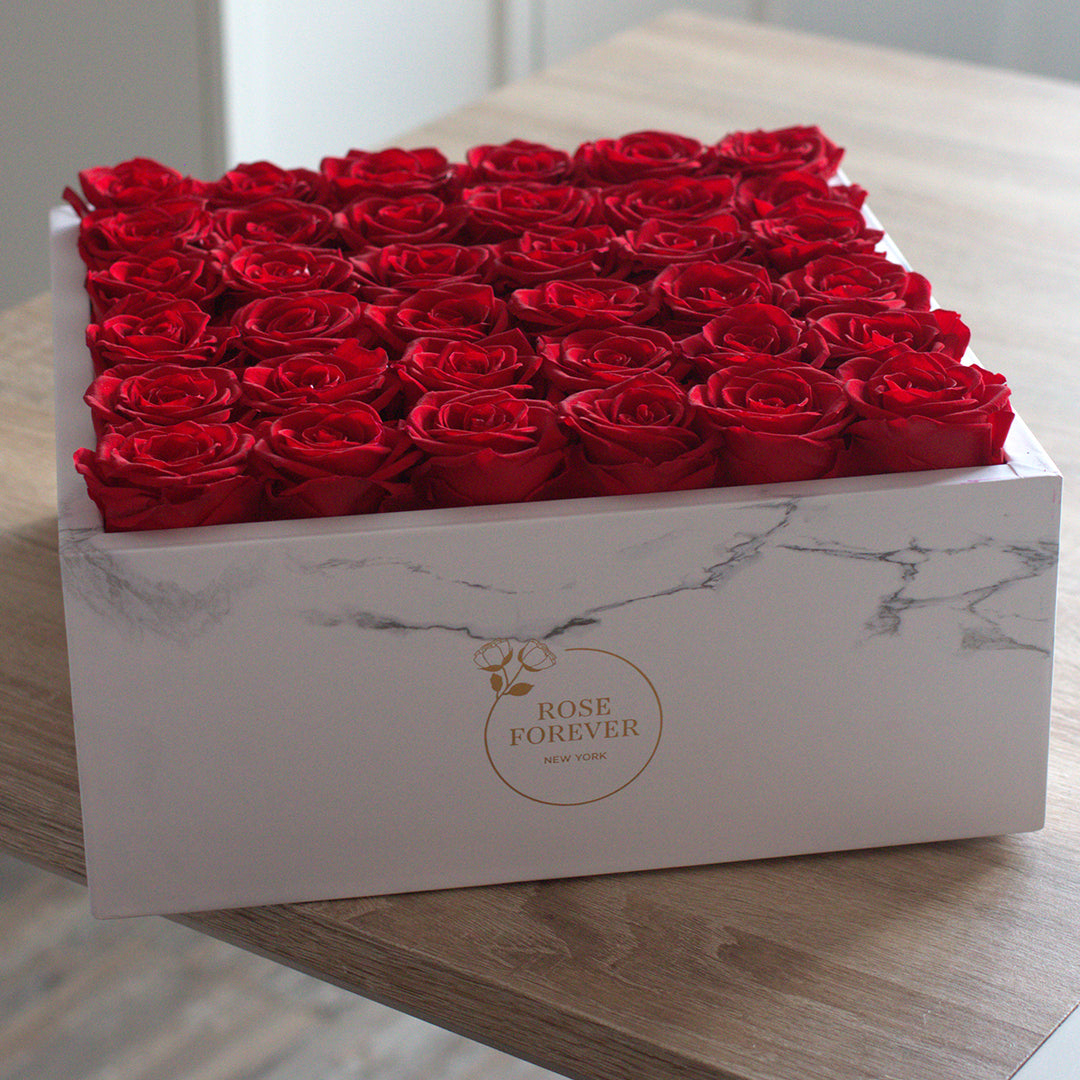 white marble box with 36 red roses
